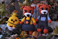 Handmade crochet woodland animal toys among autumn leaves
