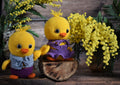 Handmade crocheted yellow chicks with vibrant flowers