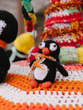 Cute handmade crochet penguin toy with colorful crafts