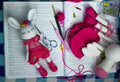 Crochet bunny toy with crochet tools on a crochet handbook