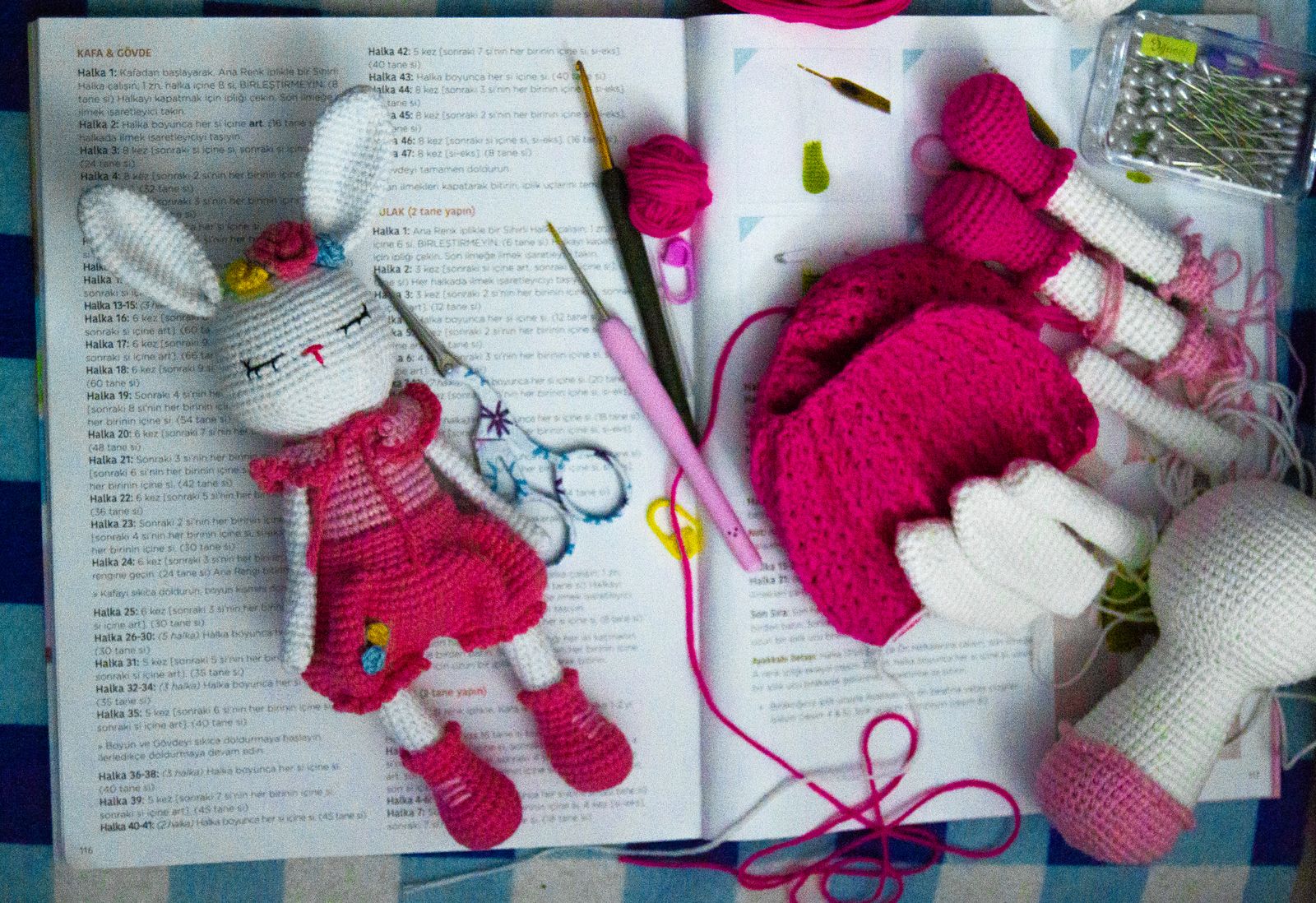 Crochet bunny toy with crochet tools on a crochet handbook